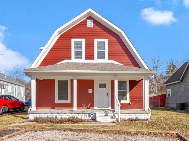 dutch colonial featuring covered porch, central AC, a gambrel roof, and roof with shingles