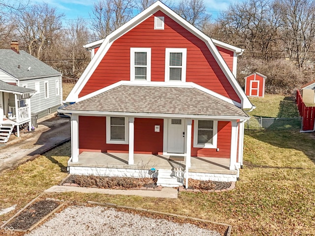 dutch colonial with roof with shingles, a porch, and a gambrel roof