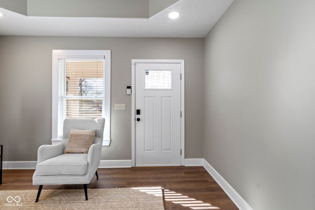 foyer entrance featuring baseboards, wood finished floors, and recessed lighting