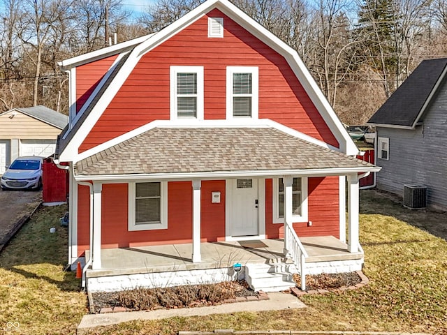 view of front facade featuring a porch, roof with shingles, cooling unit, and a gambrel roof