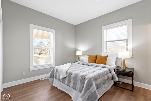 bedroom featuring baseboards and wood finished floors