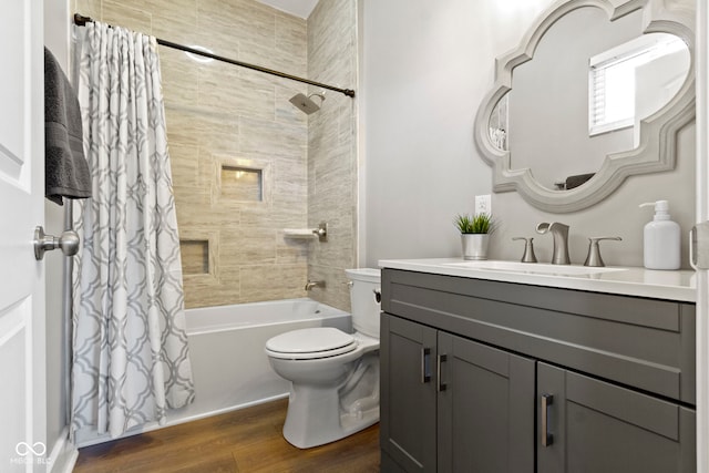 bathroom with shower / bath combo with shower curtain, vanity, toilet, and wood finished floors