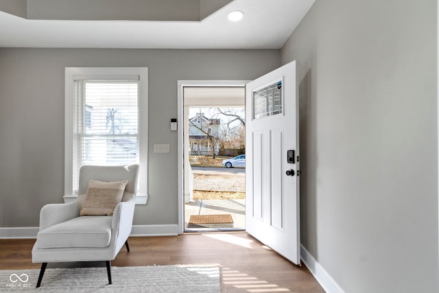 interior space featuring baseboards and wood finished floors