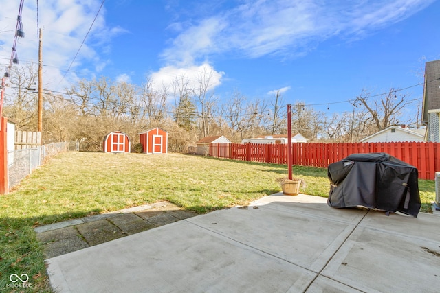 view of yard featuring an outbuilding, a fenced backyard, a patio, and a storage shed