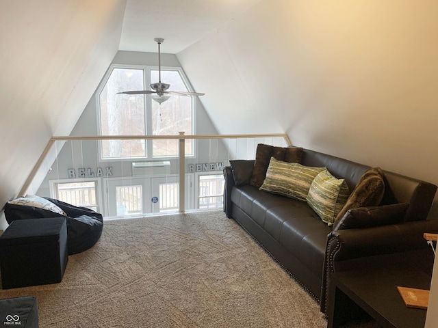 carpeted living room with ceiling fan and lofted ceiling