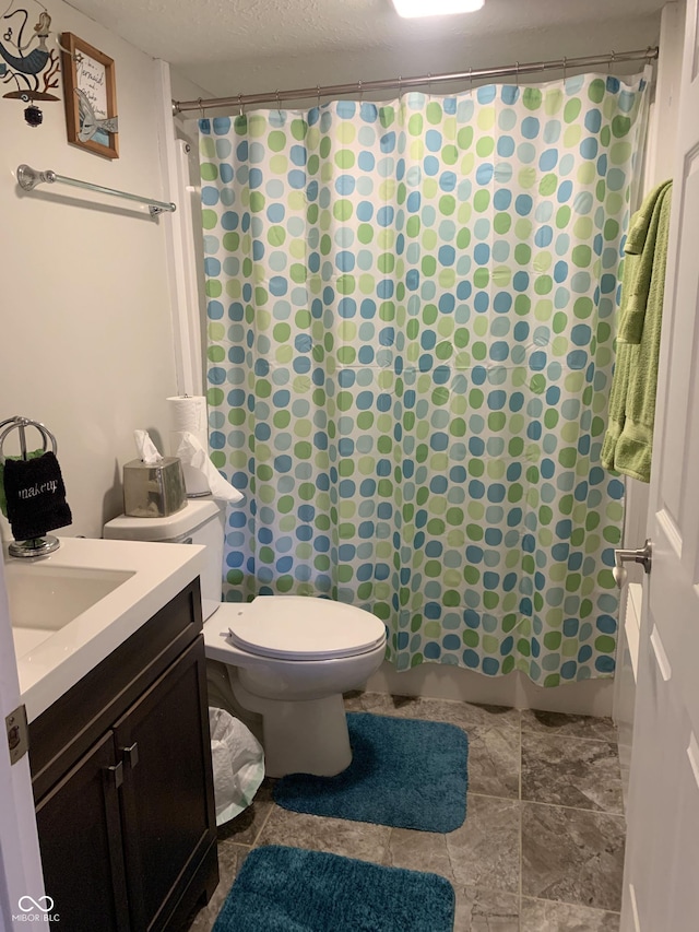 full bath with a shower with shower curtain, a textured ceiling, toilet, and vanity