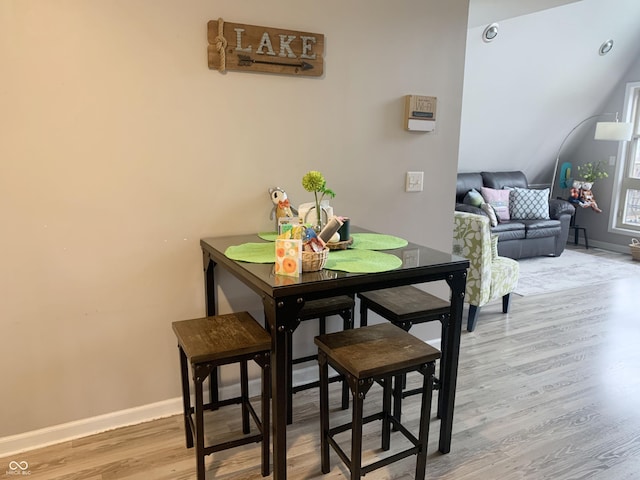 dining room featuring baseboards and light wood finished floors