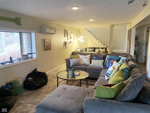 tiled living room with an AC wall unit, a textured ceiling, recessed lighting, baseboards, and stairs