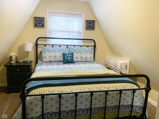 carpeted bedroom with vaulted ceiling and baseboards