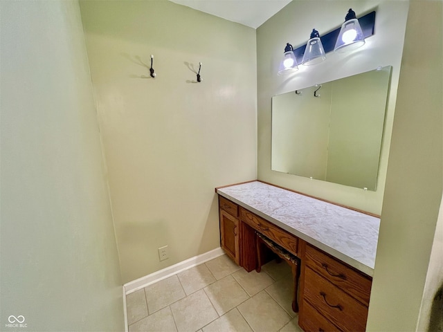 bathroom featuring vanity, baseboards, and tile patterned floors