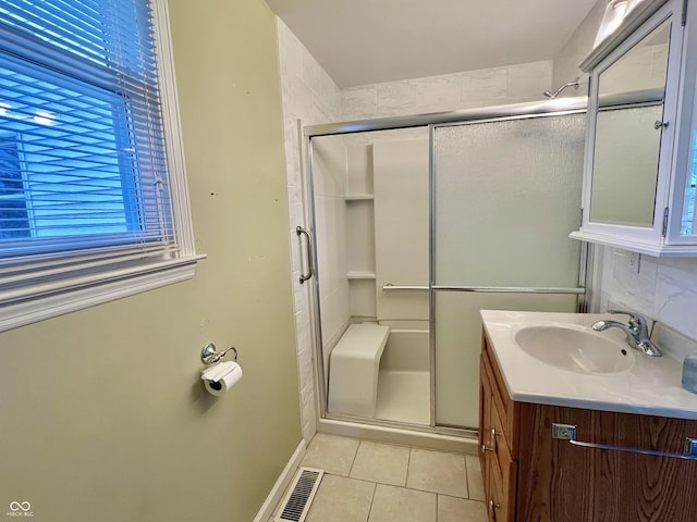 bathroom with visible vents, a stall shower, vanity, and tile patterned floors