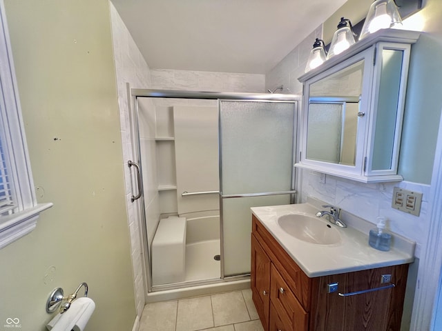 full bathroom with a stall shower, tile patterned flooring, tasteful backsplash, and vanity