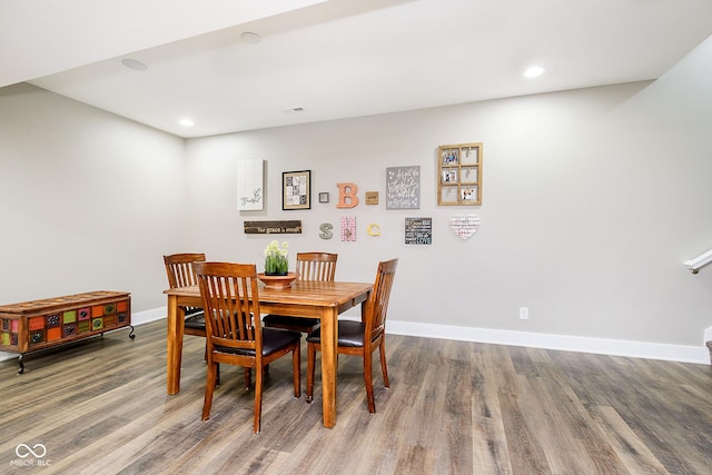 dining room featuring recessed lighting, baseboards, and wood finished floors