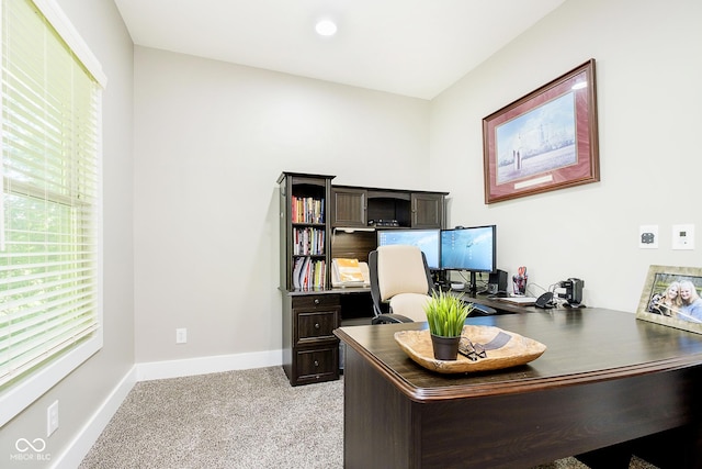 office with baseboards and light carpet