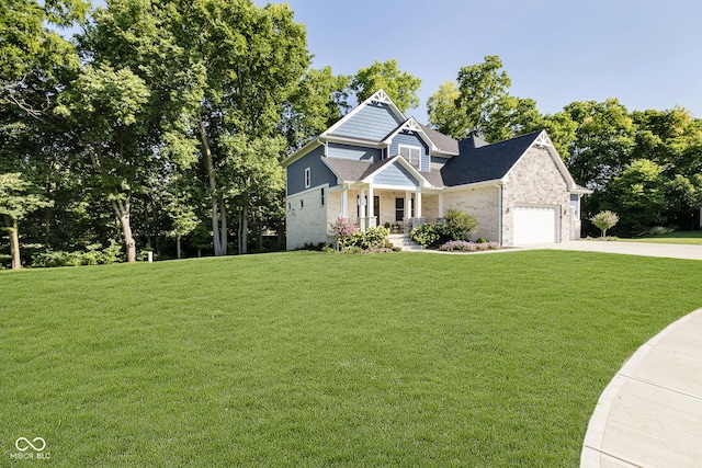 view of front of property featuring an attached garage, concrete driveway, and a front lawn