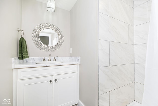 full bathroom with vanity and tiled shower