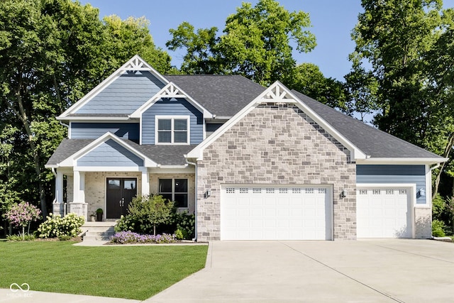 craftsman inspired home with a garage, a front yard, roof with shingles, and driveway