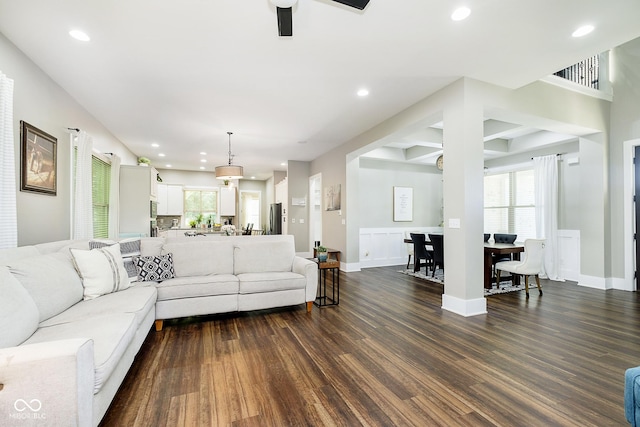 living area featuring dark wood finished floors, recessed lighting, and a wealth of natural light