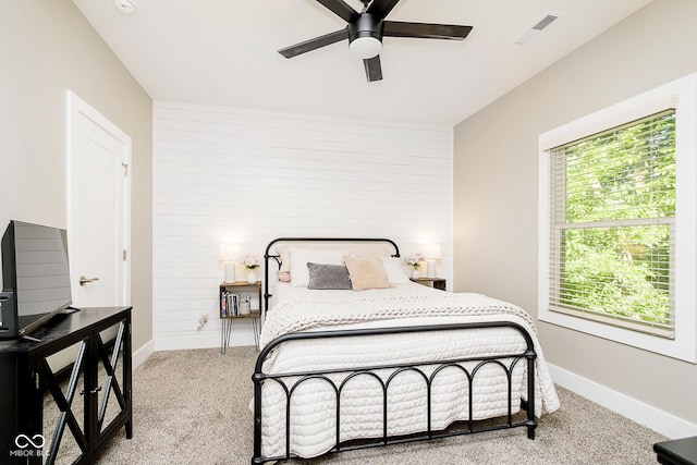 carpeted bedroom with visible vents, ceiling fan, and baseboards