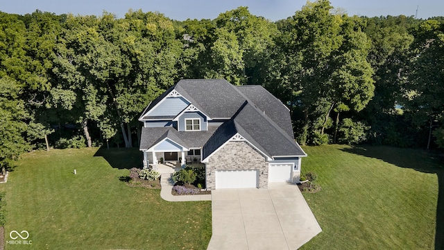 view of front of home with a front lawn, brick siding, a garage, and driveway