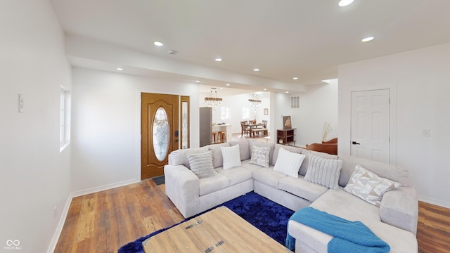 living room with baseboards, wood finished floors, visible vents, and recessed lighting