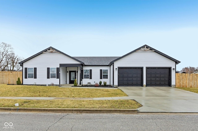 ranch-style house with a front yard, fence, driveway, and an attached garage