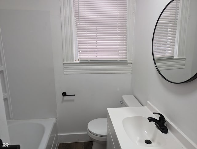 full bath featuring toilet, baseboards, and vanity