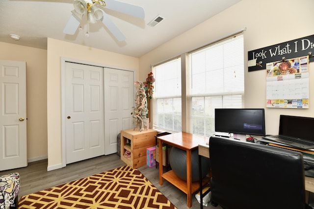 office area featuring visible vents, ceiling fan, baseboards, and wood finished floors