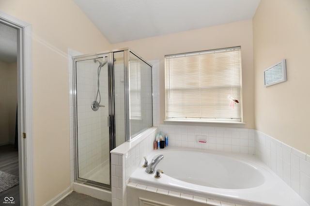 bathroom with a stall shower and a bath