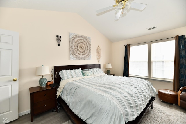 bedroom featuring visible vents, ceiling fan, vaulted ceiling, wood finished floors, and baseboards