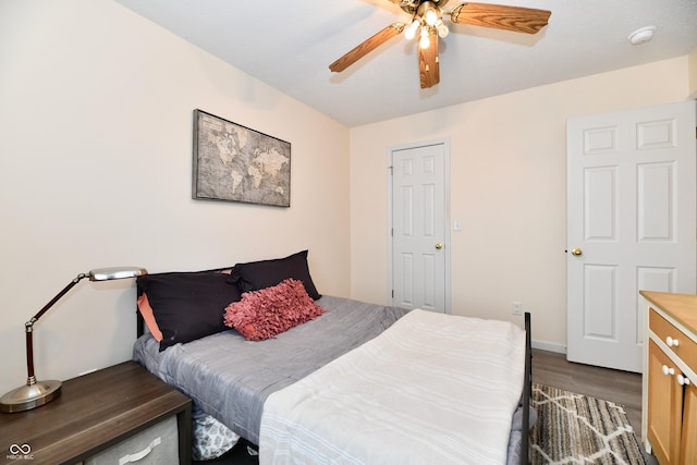 bedroom with ceiling fan and dark wood-type flooring