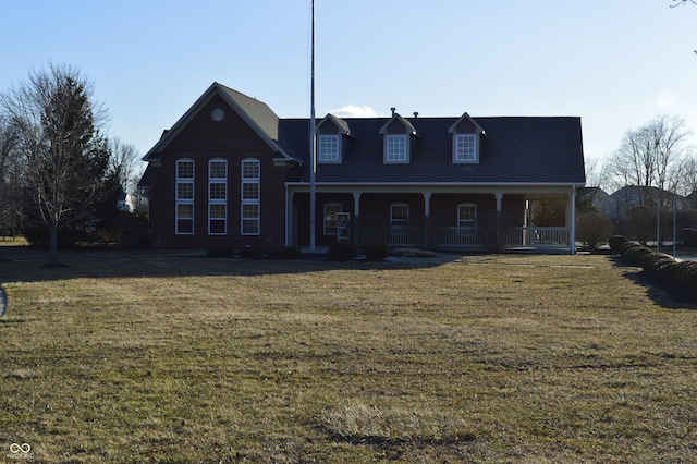 view of front of home with covered porch and a front lawn