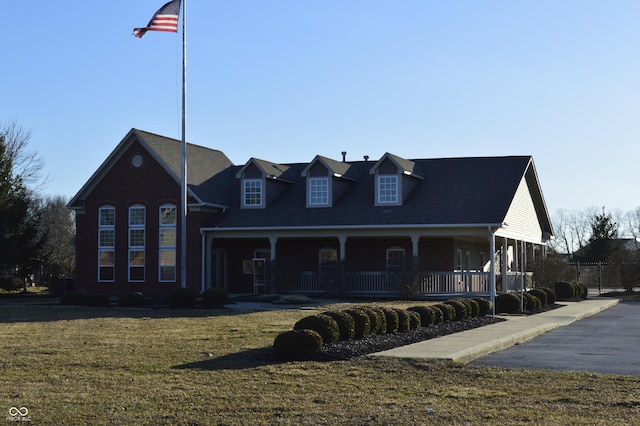 view of front of property with covered porch and a front lawn