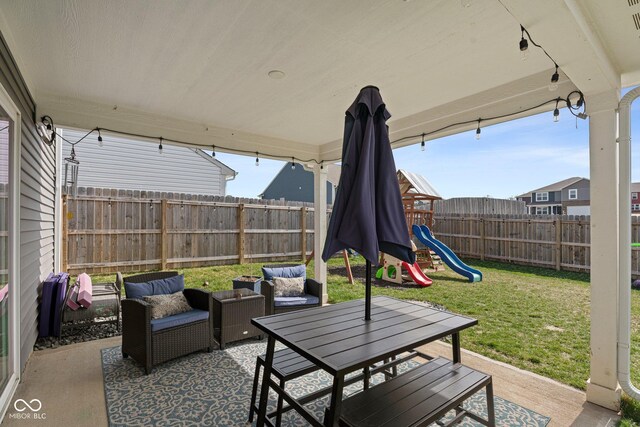 view of patio / terrace with a fenced backyard, an outdoor hangout area, and a playground