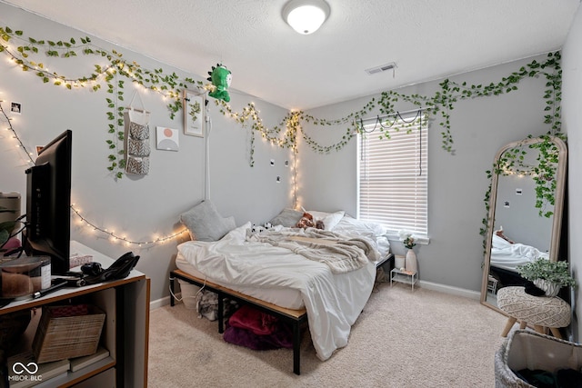 bedroom with light colored carpet, visible vents, and baseboards