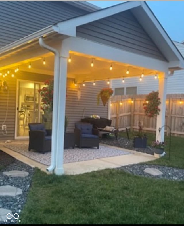 view of patio featuring fence and outdoor lounge area