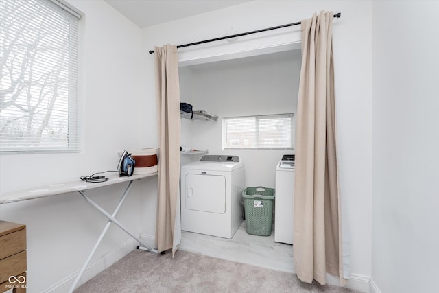 washroom with light carpet, laundry area, and washing machine and dryer