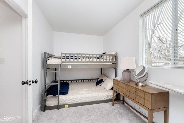 bedroom with carpet flooring and baseboards