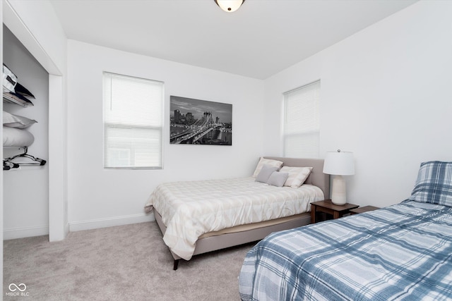 carpeted bedroom with baseboards