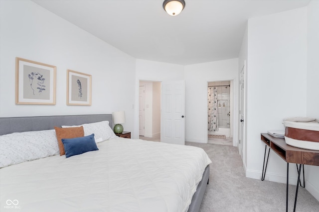 bedroom with carpet, ensuite bath, and baseboards