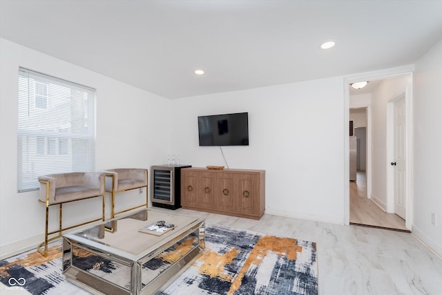 living room featuring beverage cooler, baseboards, and recessed lighting