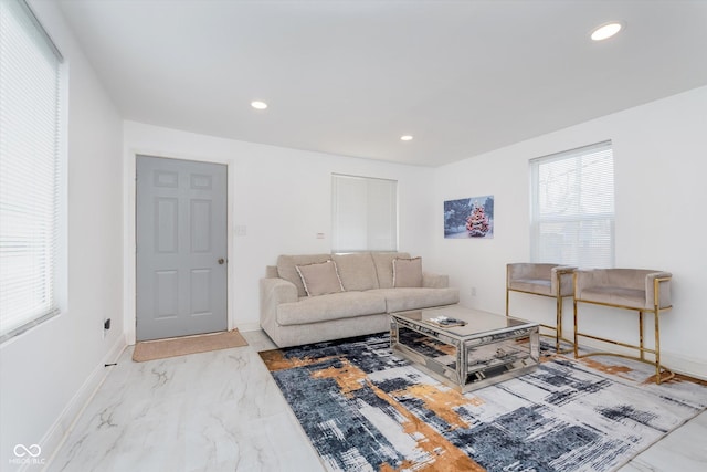 living area with marble finish floor, recessed lighting, and baseboards