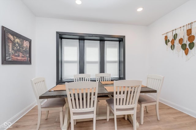 dining room with light wood-type flooring, baseboards, and recessed lighting