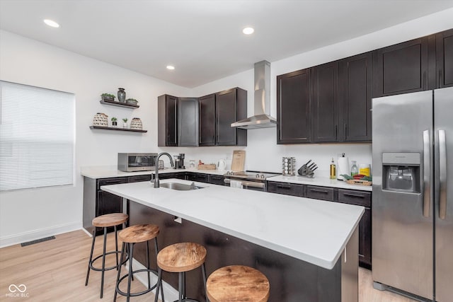 kitchen with stainless steel appliances, a sink, visible vents, wall chimney range hood, and open shelves