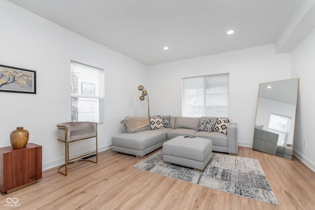 living room with recessed lighting, baseboards, and wood finished floors