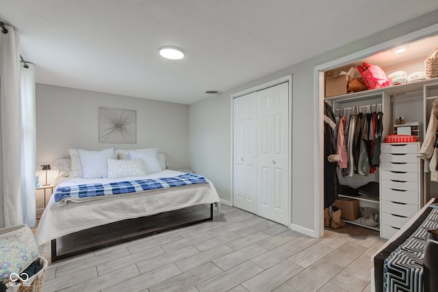 bedroom featuring wood tiled floor and baseboards