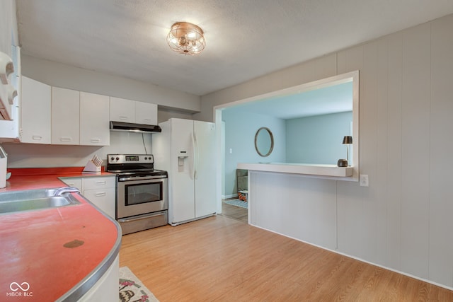 kitchen featuring under cabinet range hood, white refrigerator with ice dispenser, white cabinets, light wood finished floors, and stainless steel range with electric stovetop