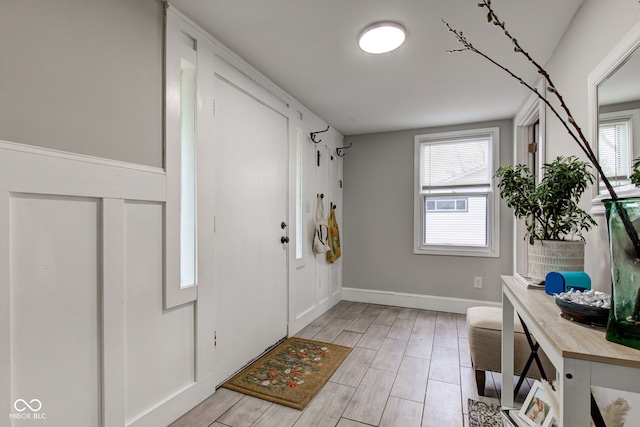 foyer entrance featuring wood finish floors and baseboards