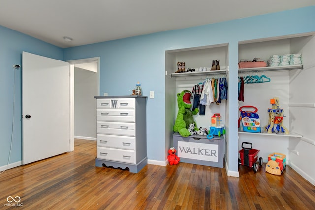 interior space with baseboards and hardwood / wood-style flooring