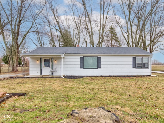 single story home with a front yard and a chimney